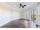 Bright bedroom featuring hardwood floors, ceiling fan and sliding glass doors leading to a balcony at 1 Biscayne Nw Dr # 809, Atlanta, GA 30309