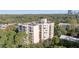 Multi-story condominium building with trees and lush landscaping surrounding the property in a suburban neighborhood at 1 Biscayne Nw Dr # 809, Atlanta, GA 30309