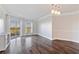 Bright living room featuring hardwood floors, modern lighting, and sliding glass doors leading to a balcony at 1 Biscayne Nw Dr # 809, Atlanta, GA 30309