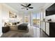 A spacious main bedroom features a ceiling fan, dark wood floors, and access to a balcony at 1 Biscayne Nw Dr # 809, Atlanta, GA 30309