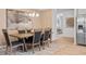 Inviting dining space with modern chandelier and stainless steel refrigerator in a neutral color palette at 120 Asher Dr, Carrollton, GA 30116