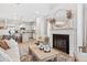 Cozy living room featuring a fireplace, with a view of the modern kitchen and dining area at 120 Asher Dr, Carrollton, GA 30116