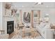 Bright living room featuring a fireplace, decorative mirror, and comfortable seating at 120 Asher Dr, Carrollton, GA 30116