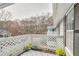 Balcony view with wooden railing, striped mat, and potted flowers at 204 Natchez Trce, Sandy Springs, GA 30350