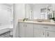 Bright bathroom with a large mirror, white vanity, and shower/tub combination at 204 Natchez Trce, Sandy Springs, GA 30350