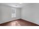 Bright bedroom features hardwood floors, window, and neutral paint at 204 Natchez Trce, Sandy Springs, GA 30350