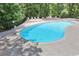 The community pool is fenced in and surrounded by mature trees at 204 Natchez Trce, Sandy Springs, GA 30350