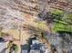 Aerial shot highlights a backyard fire pit, meandering path, and relaxing deck area at 775 River Cliff Ct, Suwanee, GA 30024