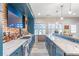 The bar features a brick accent wall, TV, a marble counter and a beer and wine cooler at 775 River Cliff Ct, Suwanee, GA 30024