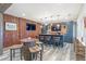 This finished basement includes a bar with an accent wall, mounted TVs and a wine barrel table at 775 River Cliff Ct, Suwanee, GA 30024