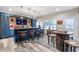 The bar is a entertaining space, with a brick accent wall, TV, wooden barrel table and ample seating at 775 River Cliff Ct, Suwanee, GA 30024