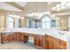 Bright bathroom with a large vanity, double sinks, many drawers and cabinets and a huge mirror at 775 River Cliff Ct, Suwanee, GA 30024