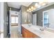 Gray bathroom featuring a double sink vanity, a large mirror, and neutral-colored walls at 775 River Cliff Ct, Suwanee, GA 30024