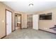 Bedroom with neutral walls, carpet flooring, and doors leading to other rooms of the house at 775 River Cliff Ct, Suwanee, GA 30024