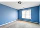 Blue bedroom with light carpet, one window with blinds, and good sunlight at 775 River Cliff Ct, Suwanee, GA 30024