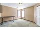 Bedroom with neutral walls, carpet flooring, and a gaming table beneath two bright windows at 775 River Cliff Ct, Suwanee, GA 30024