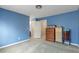 This bedroom has blue walls, carpet, 3 dressers and an ensuite bathroom at 775 River Cliff Ct, Suwanee, GA 30024