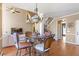 View of the dining room featuring stairs to second floor with a chandelier and hardwood flooring at 775 River Cliff Ct, Suwanee, GA 30024