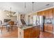 This kitchen includes a center island, stainless refrigerator, and adjacent dining area with chandelier at 775 River Cliff Ct, Suwanee, GA 30024