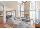 Bright living room boasts high ceilings, a stone fireplace, large windows, and an open layout at 775 River Cliff Ct, Suwanee, GA 30024