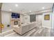 Cozy basement living room with fireplace, TV, and a sliding barn door at 775 River Cliff Ct, Suwanee, GA 30024