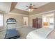 Bright main bedroom features tray ceiling, ceiling fan, and a bay window with plantation shutters at 775 River Cliff Ct, Suwanee, GA 30024