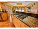 Gourmet kitchen featuring granite countertops, a cooktop island, and natural lighting at 2113 Woodland Dr, Hapeville, GA 30354