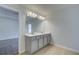 Double vanity bathroom with gray cabinets and a large mirror at 317 Heavenly Hollow Pl, Mcdonough, GA 30253