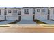 Modern townhome exterior showcasing neutral paint, individual garages, and manicured landscaping at 317 Heavenly Hollow Pl, Mcdonough, GA 30253