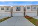 Modern townhome exterior featuring a wide driveway and attached garages and nicely landscaped front yards at 317 Heavenly Hollow Pl, Mcdonough, GA 30253