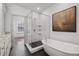Modern bathroom with glass-enclosed shower, soaking tub, and contemporary finishes at 607 Broadview Ter, Atlanta, GA 30324