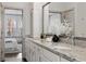 Double vanity bathroom with granite countertops, white cabinets, and decorative accents at 607 Broadview Ter, Atlanta, GA 30324