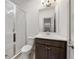 Bright bathroom featuring a glass-enclosed shower, modern vanity, and neutral finishes at 607 Broadview Ter, Atlanta, GA 30324