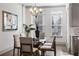 Bright dining room featuring a glass table, seating for four, and modern chandelier at 607 Broadview Ter, Atlanta, GA 30324