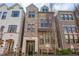 Three-story brick townhome featuring a classic facade, large windows, and an appealing residential street presence at 607 Broadview Ter, Atlanta, GA 30324