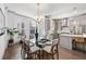 Open concept kitchen and dining area with modern appliances, island, table and chairs, and ample lighting at 607 Broadview Ter, Atlanta, GA 30324
