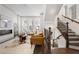 Bright living room featuring a modern fireplace, shaggy rug, and adjacent staircase at 607 Broadview Ter, Atlanta, GA 30324