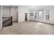 Open loft with a staircase, bathroom access, and outdoor entry with modern black shelving at 607 Broadview Ter, Atlanta, GA 30324