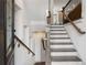 Grand staircase with hardwood steps, a white painted frame, and stylish fixtures connecting the home's levels at 607 Broadview Ter, Atlanta, GA 30324