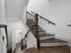 Staircase with dark wood steps, white risers, and wrought iron railing at 607 Broadview Ter, Atlanta, GA 30324