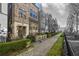 Attractive street view of a brick townhome featuring a well-maintained garden and a quaint neighborhood setting at 607 Broadview Ter, Atlanta, GA 30324