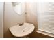 Small bathroom with pedestal sink, mirror and window at 3301 Cascade Parc Blvd, Atlanta, GA 30311