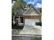 Two-story house with stone and siding accents, a two-car garage, and a landscaped yard at 3301 Cascade Parc Blvd, Atlanta, GA 30311