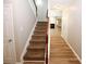 Staircase with brown carpet and wooden railing leading to the second floor at 3301 Cascade Parc Blvd, Atlanta, GA 30311