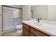 Bathroom featuring a walk-in shower, cherry vanity, light countertops and a modern sink at 55 Burns View Ct, Lawrenceville, GA 30044