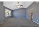 Bedroom boasts vaulted ceilings, a ceiling fan, and a doorway leading to an ensuite bathroom, creating a private retreat at 55 Burns View Ct, Lawrenceville, GA 30044