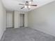 A spacious bedroom featuring plush carpeting, a ceiling fan and a closet with shelving at 55 Burns View Ct, Lawrenceville, GA 30044