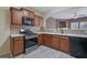 A modern kitchen with stainless steel appliances, mosaic backsplash, light countertops and view of the open living area at 55 Burns View Ct, Lawrenceville, GA 30044