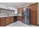 A well-lit kitchen featuring stainless steel appliances, mosaic backsplash, wood cabinets, and modern countertops at 55 Burns View Ct, Lawrenceville, GA 30044