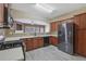 Modern kitchen with stainless steel refrigerator, lots of cabinet space, and black appliances at 55 Burns View Ct, Lawrenceville, GA 30044